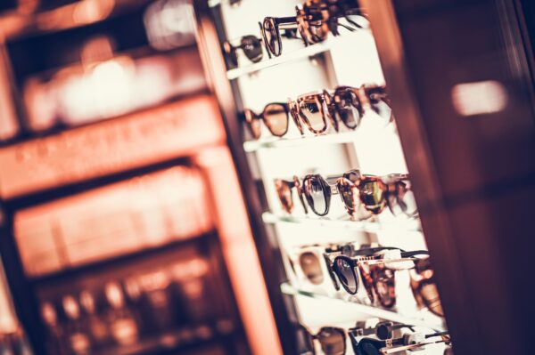 Selection of Brand New Designer Sunglasses. Glasses Store Rack.